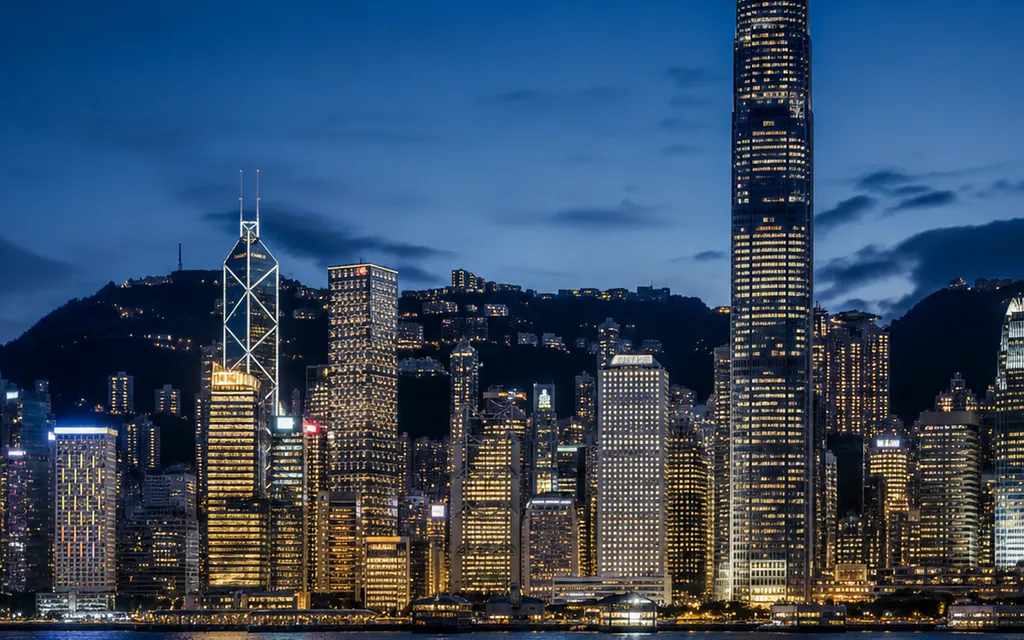 Hong Kong skyline across Victoria Harbour at night.